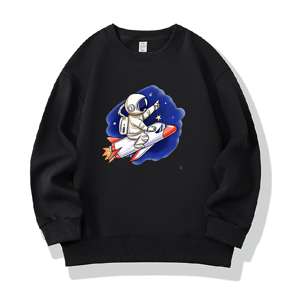 Kids black sweatshirt with astronaut riding a rocket graphic, surrounded by stars. Perfect for space-themed adventures in style.